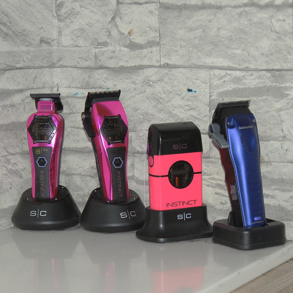 Pink barber clippers on a clean station